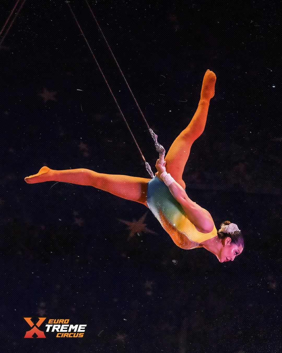 Aerial circus artist performing above the stage