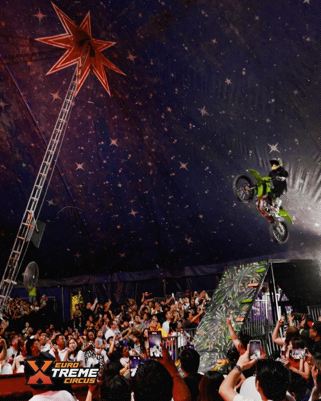 FMX rider performing above the audience inside the Euro Xtreme Circus big top