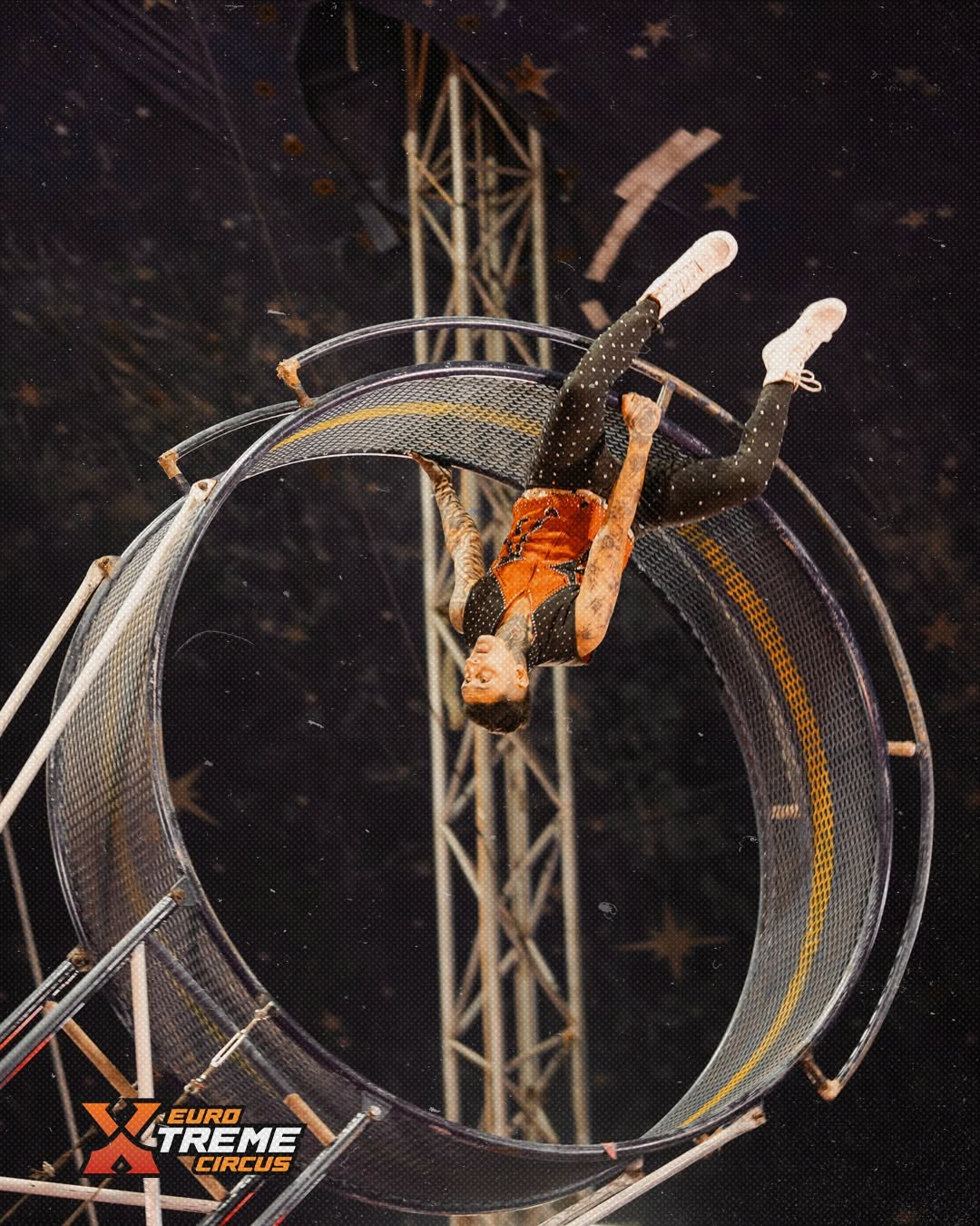 Circus artist performing a high wheel balancing act